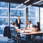 Professional financial experts collaborating during brainstorming meeting listening information from clever female director, businesswoman providing information to corporate workers of company